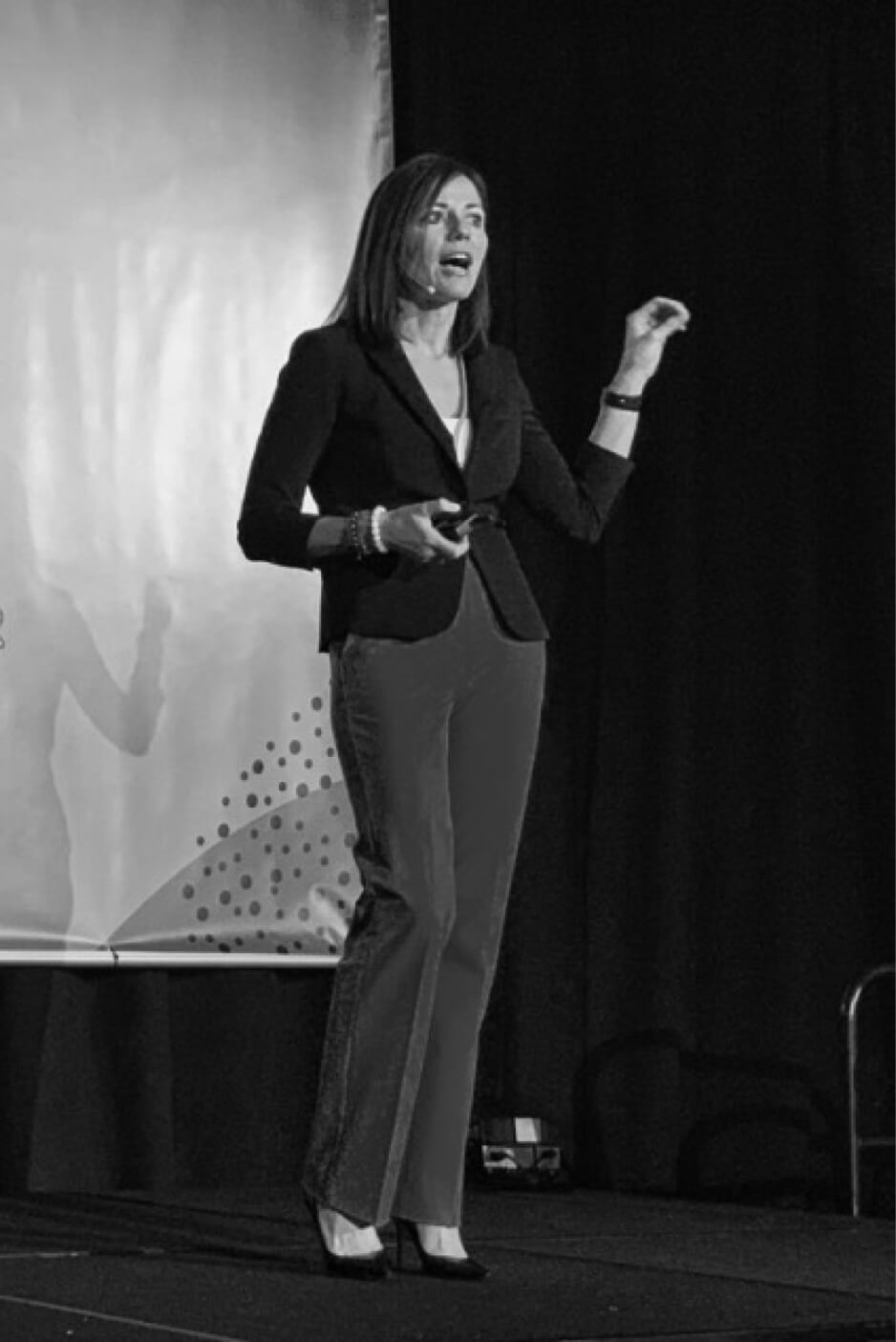 black and white photo of linda m perry speaking on stage